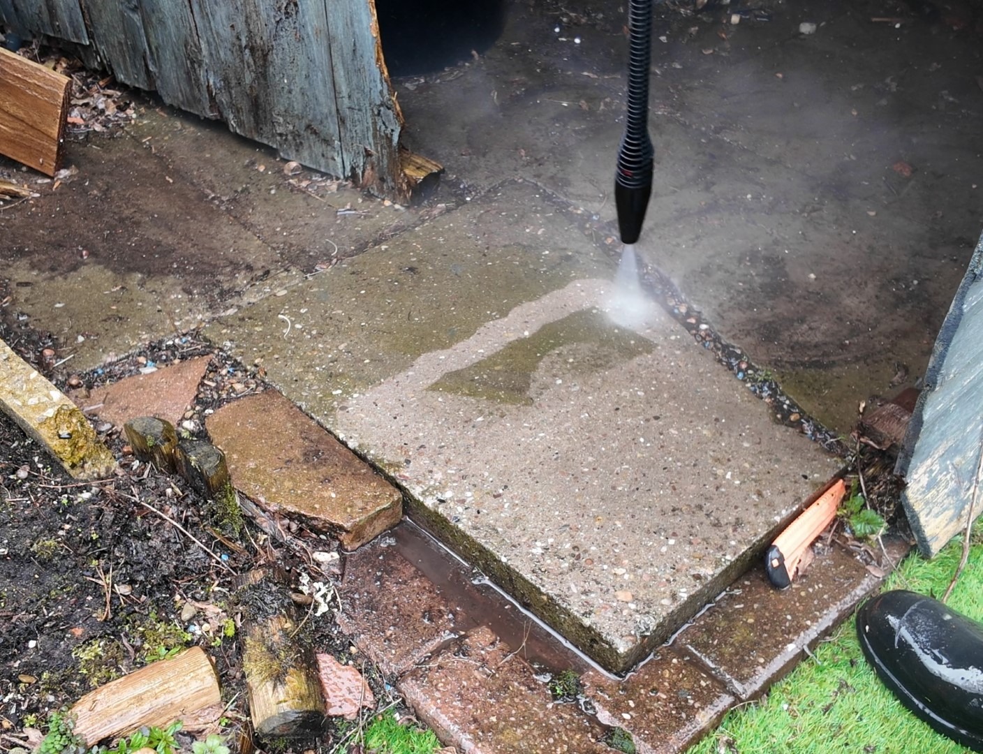Hidrolimpiadora Parkside limpiando losas de piedra en un patio exterior con agua a presión